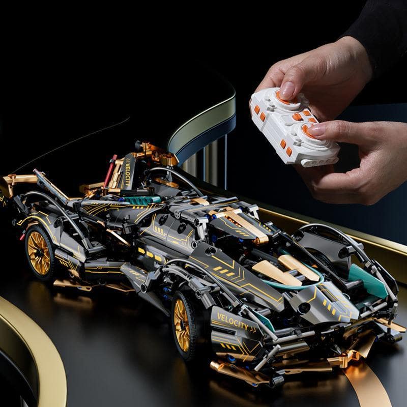 High-tech black and gold LEGO sports car model on a sleek black surface, controlled by a person using a remote, showcasing innovative building toys at Monalisa Store.
