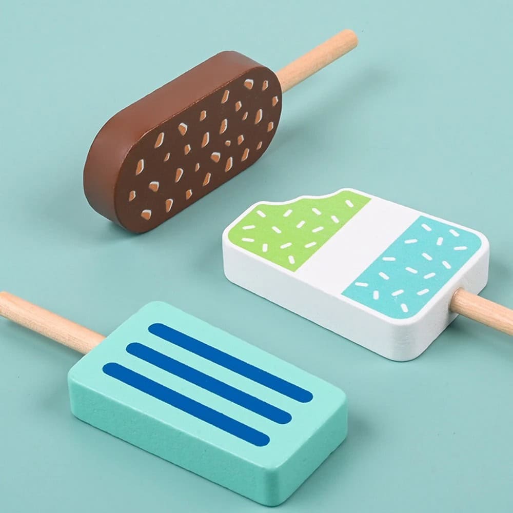 Light blue background with three colorful wooden popsicle toys featuring playful patterns, perfect for children's entertainment and educational activities.