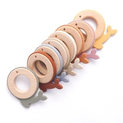 Colorful wooden teething rings with whale-shaped accents, suitable for infants and toddlers, designed to promote sensory development and soothe teething discomfort.