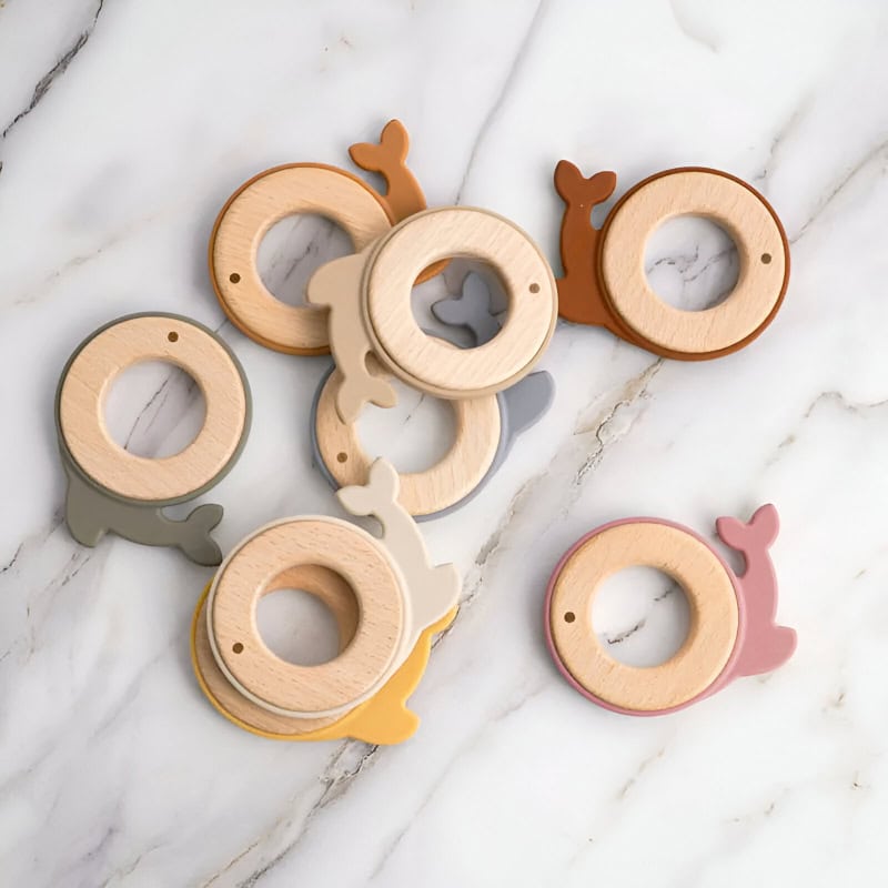Wooden baby teething rings with whale tails, colorful teething toys for infants, safe natural teething rings for babies, Montessori-style teethers for kids, plastic-free teething accessories for infants.