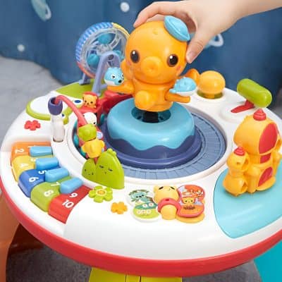 Colorful children's educational and activity table with animal-themed toys and interactive features for early childhood development.
