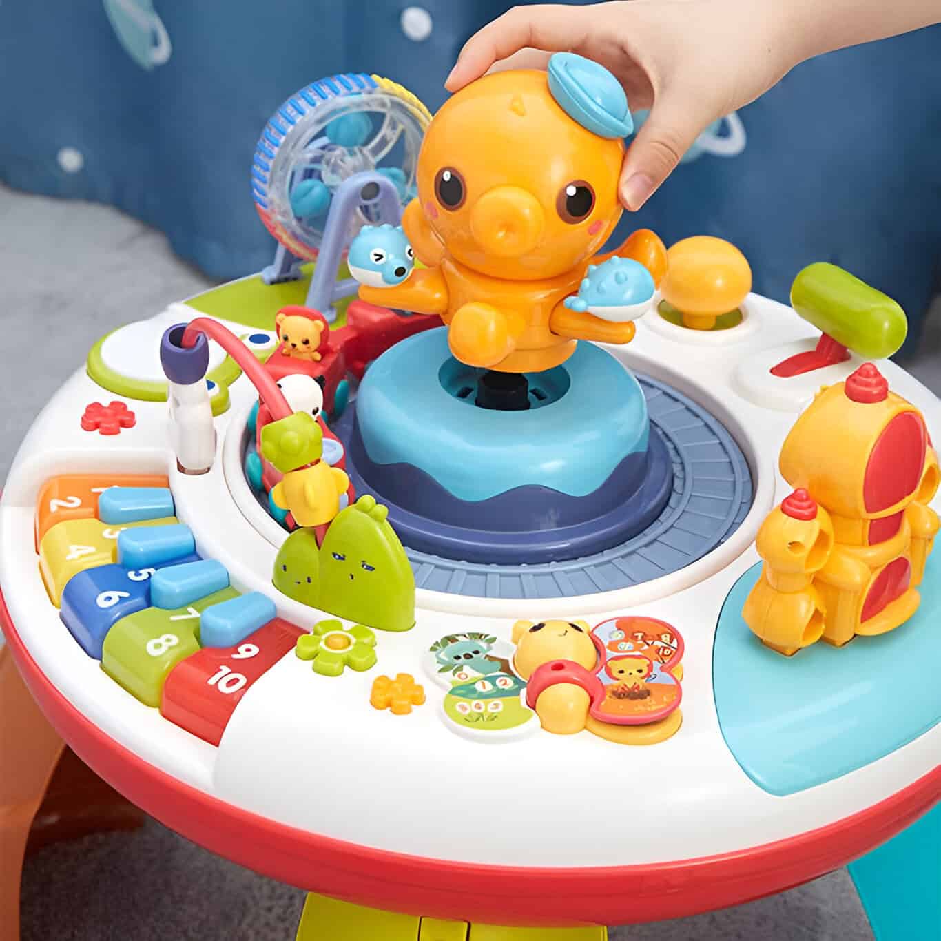 Colorful children's educational and activity table with animal-themed toys and interactive features for early childhood development.