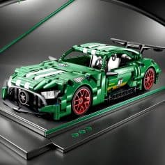 LEGO Technic Ferrari Race Car model in vibrant green with red accents, detailed exterior, and racing decals, displayed on a sleek black platform, showcasing precision craftsmanship and collector's appeal.