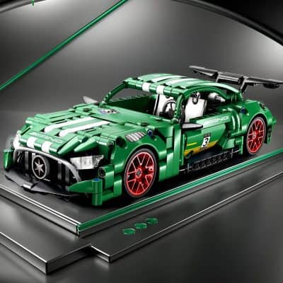LEGO Technic Ferrari Race Car model in vibrant green with red accents, detailed exterior, and racing decals, displayed on a sleek black platform, showcasing precision craftsmanship and collector's appeal.