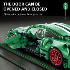 Lego model of a car with a green body and red wheels, detailed interior with steering wheel, made from building blocks, displayed on a black surface for Monalisa Medical store website.