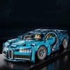 Lego Bugatti Chiron supercar model, detailed and realistic, displayed on a tabletop against a dark background, showcasing a luxurious and intricate collectible toy car.