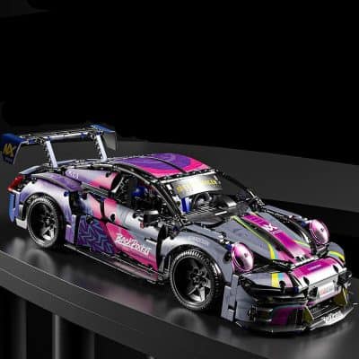 High-performance racing car model with vibrant pink, purple, and yellow decals, featuring detailed aerodynamic design, racing tires, and rear spoiler, displayed on a sleek black platform at Monalisa Store.