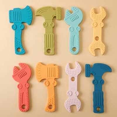 Colorful silicone baby teethers in hammer and wrench shapes, designed for infants' teething relief and sensory development, available at Monalisa Store.