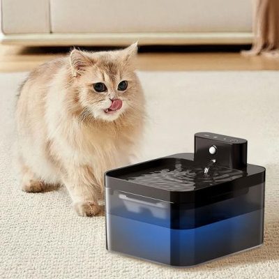 Cute long-haired cat drinking from a pet water fountain in a modern home setting.