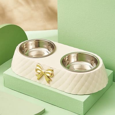Double pet food bowl with gold bow decoration for pets, stylish stainless steel dog and cat feeding station, elegant pet dining accessory from Monalisa Store.