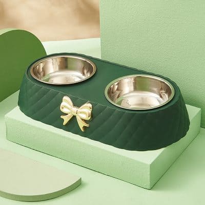 Double pet feeding bowl with bow detail, green and gold colors, stylish animal feeding accessory for pets at Monalisa Medical store.