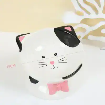 Cute cat-shaped piggy bank with adorable facial features and pink bow, ideal for kids' savings and gifting.