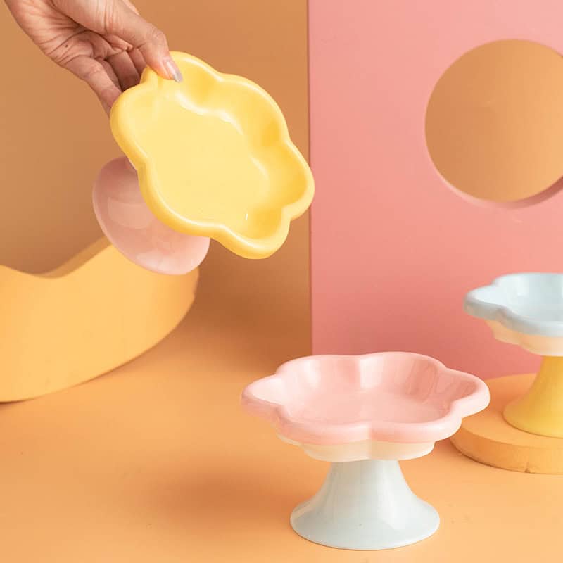 Flower-shaped ceramic dessert tray, pastel yellow, pink, and blue decorative plates on stands, stylish kitchenware from Monalisa Store, perfect for elegant serving and home decor, ideal for modern kitchen designs, high-quality and trendy tableware, home accessories for special occasions.