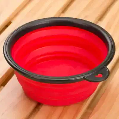 Flexible red collapsible silicone bowl with black rim for easy storage and versatile kitchen use from Monalisa Medical Store.
