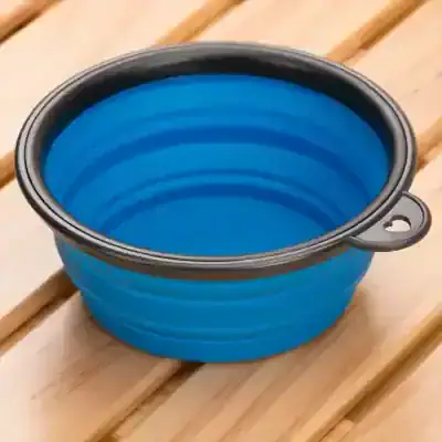Collapsible blue silicone travel bowl for pets, lightweight and portable, perfect for outdoor adventures, camping, and hiking with dogs or cats.