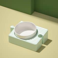 White ceramic pet bowl on a pastel green textured stand for pet feeding, minimalistic design, kitchen decor, Monalisa Store.