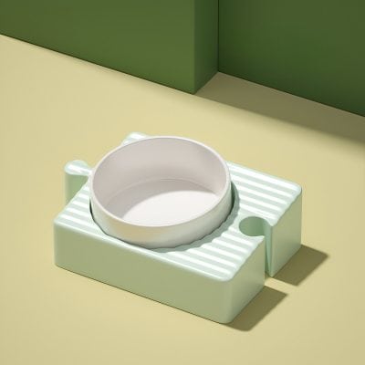 White ceramic pet bowl on a pastel green textured stand for pet feeding, minimalistic design, kitchen decor, Monalisa Store.
