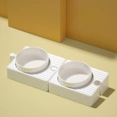 Multiple ceramic pet food bowls on a white ceramic mat for easy cleaning, suitable for homes with cats or small dogs. Perfect for maintaining hygiene and organization in your pet's feeding area.