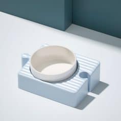 Ceramic pet food bowl, modern minimalist pet feeding dish on white and blue background, stylish animal bowl for cats and dogs.