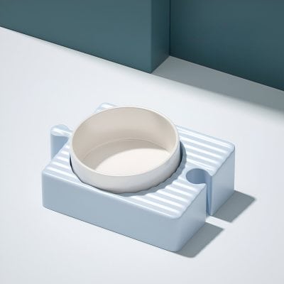 Ceramic pet food bowl, modern minimalist pet feeding dish on white and blue background, stylish animal bowl for cats and dogs.
