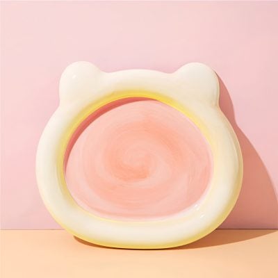 Soft pink and white bear-shaped night light with warm glow, perfect for children's bedrooms and adding cozy ambiance to any space.