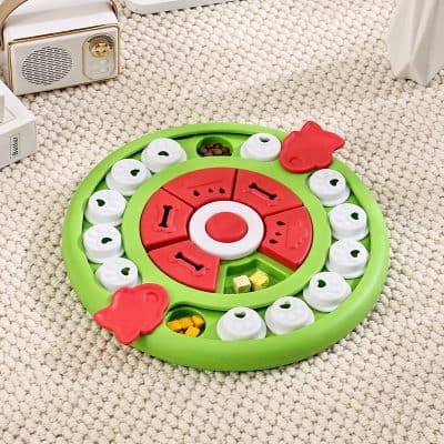 Green and red puzzle toy with rotating pieces and small compartments, designed for children’s entertainment and development. Features colorful shapes, animal figures, and storage spaces, perfect for early learning activities.
