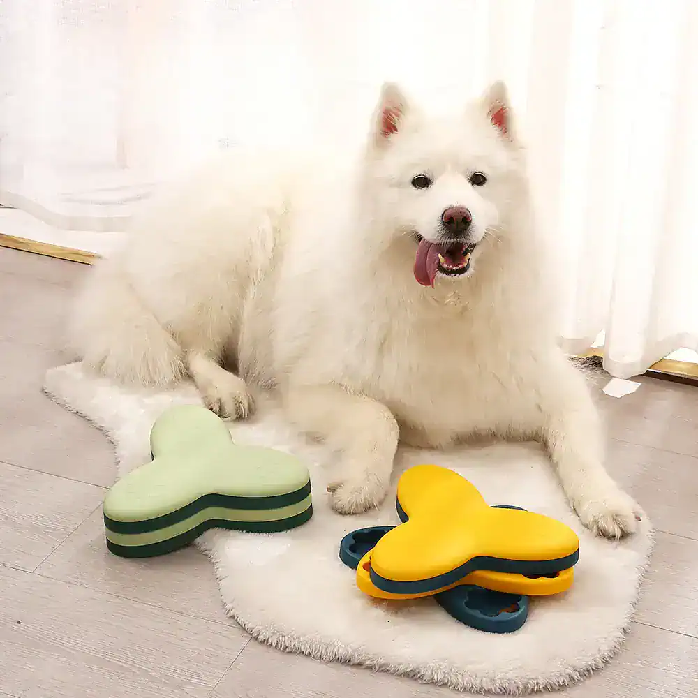 Fluffy white dog sitting on a soft rug with dog toys, joyful and playful, in a bright room.