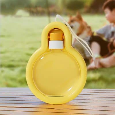 Bright yellow floatation device for dogs on a wooden surface with outdoor park background and a child playing with a dog, emphasizing pet safety during water activities.