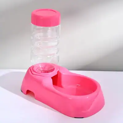 Pink pet feeding station with a water dispenser and bowl for pets.
