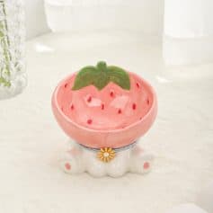 Strawberry-themed decorative ceramic bowl with a green leaf detail, ideal for home decor or kitchen storage.
