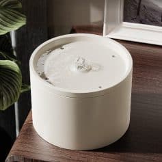 Elegant white water fountain, modern design perfect for home or office decoration, featuring calming water flow and smooth rounded shape.