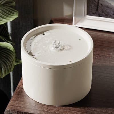 Elegant white water fountain, modern design perfect for home or office decoration, featuring calming water flow and smooth rounded shape.