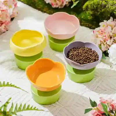 Colorful ceramic bowls with lush greenery and flowers in the background, perfect for serving tea, snacks, or decor, showcasing elegant design and vibrant colors.