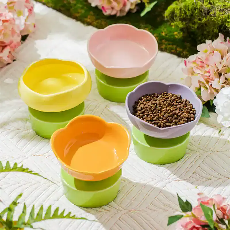 Colorful ceramic bowls with lush greenery and flowers in the background, perfect for serving tea, snacks, or decor, showcasing elegant design and vibrant colors.