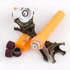 Precision dental tools and whitening gel with a miniature Eiffel Tower decor, emphasizing advanced dental care products and aesthetic teeth whitening solutions for a brighter smile.