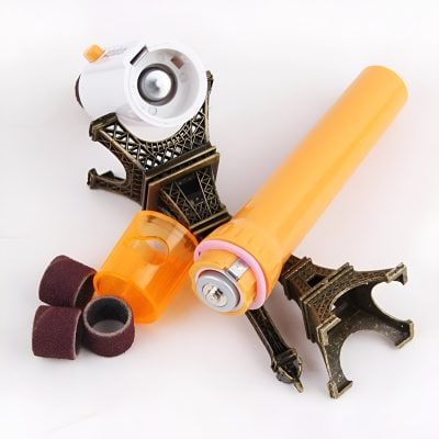 Precision dental tools and whitening gel with a miniature Eiffel Tower decor, emphasizing advanced dental care products and aesthetic teeth whitening solutions for a brighter smile.