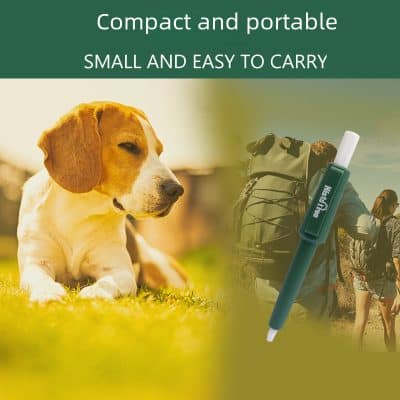 Dog lying on grass with a portable medical device for pets and humans, suitable for travel and outdoor use.