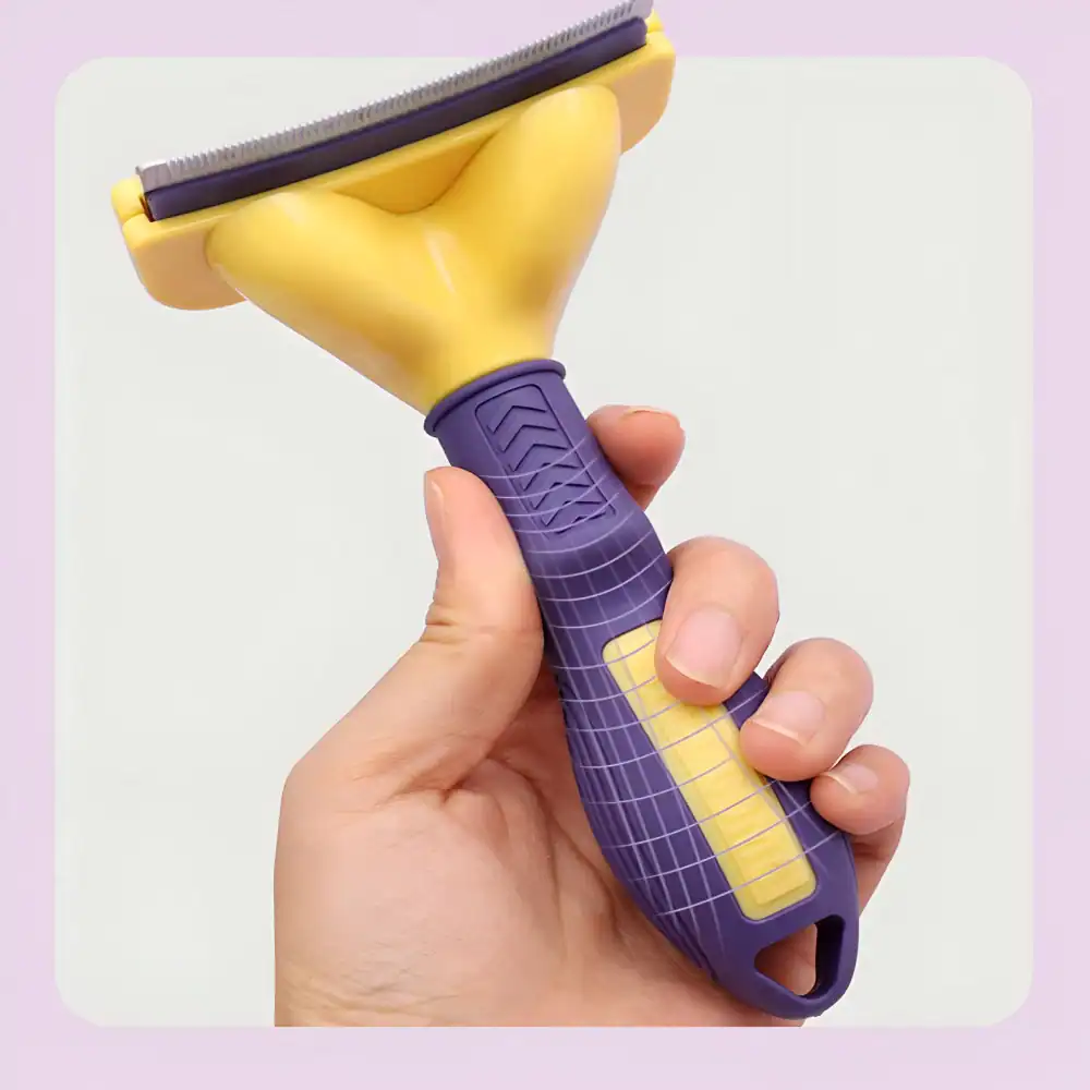 Bright yellow and purple pet grooming brush with ergonomic handle for easy grooming and hair removal.