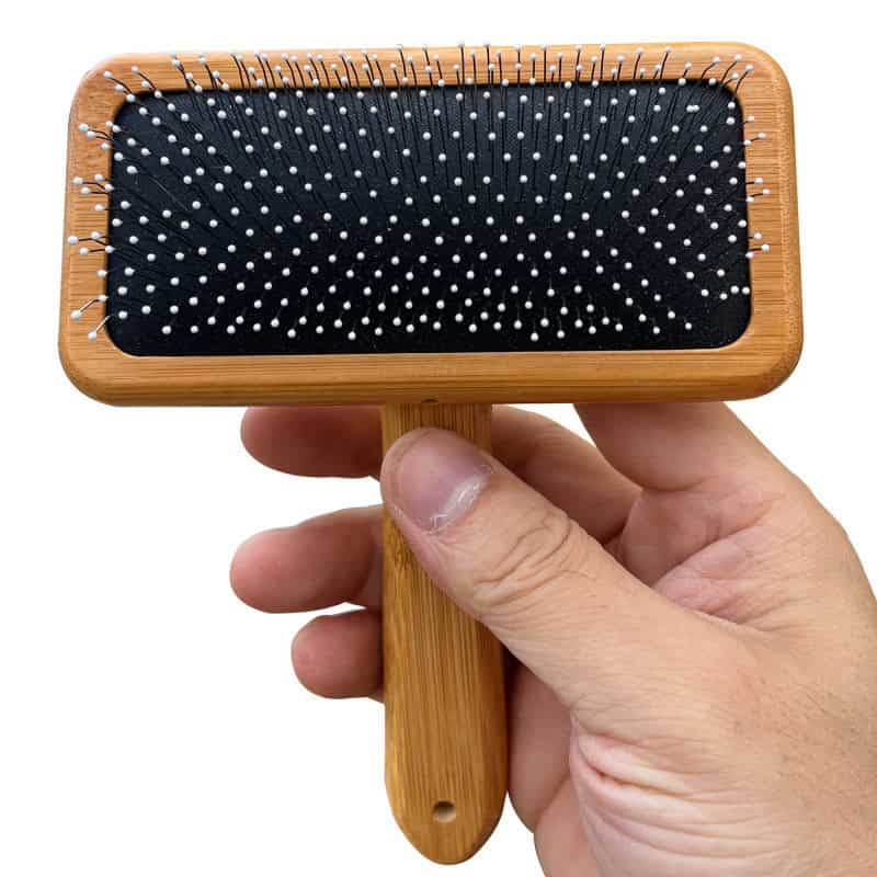 Black and white pin cushion cleaning brush with a wooden handle, ideal for eyeglass and optical frame cleaning at Monalisa Store. Durable and easy to use for maintaining clear vision.