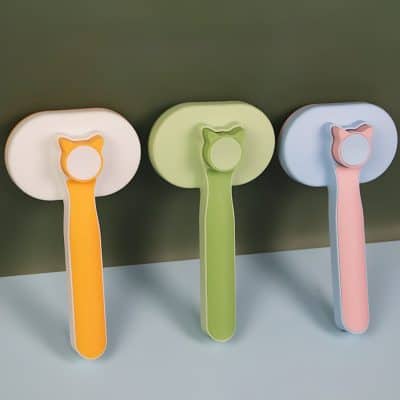 Colorful handheld fan with cat-shaped handle in orange, green, and pink, designed for personalized cooling solutions at Monalisa Medical store.