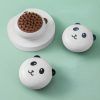 Panda-shaped chocolate fondue pots set on pastel background.