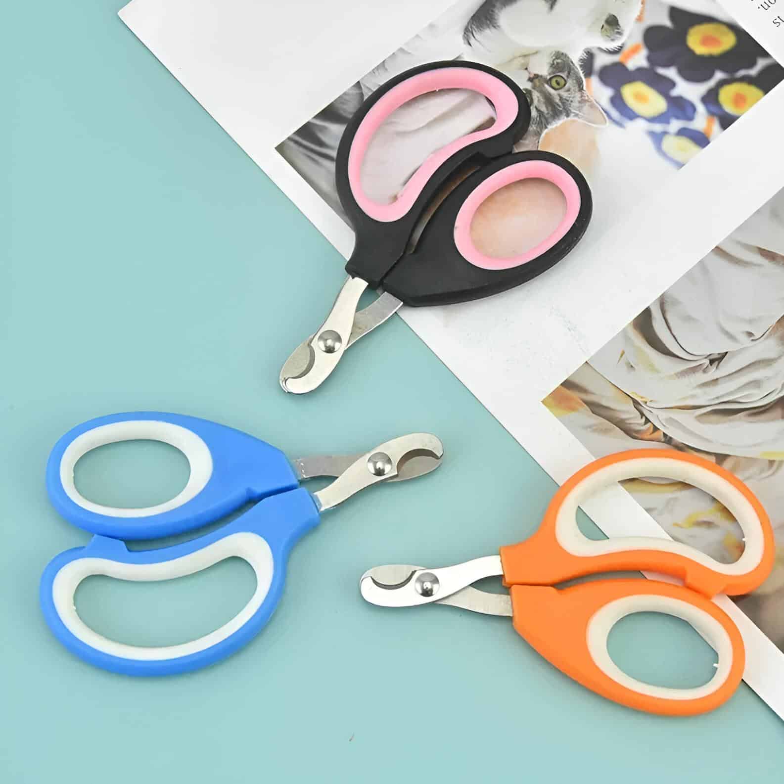 Stainless steel baby safety scissors with colorful silicone handles in blue, pink, and orange, ideal for gentle trimming and grooming. Perfect for parent and child care at Monalisa Store.