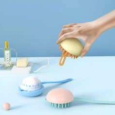 Multi-functional silicone body brushes with ergonomic handles for deep cleaning and exfoliation, displayed with skincare products on a pastel blue background, ideal for personal care and beauty routines.