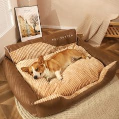 Pet dog relaxing in pet bed with plush internal cushion and brown leather-like exterior.