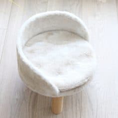 Soft white plush pet bed with a cozy round design, perfect for cats and small dogs, available at Monalisa Store for comfortable and stylish pet sleeping options.