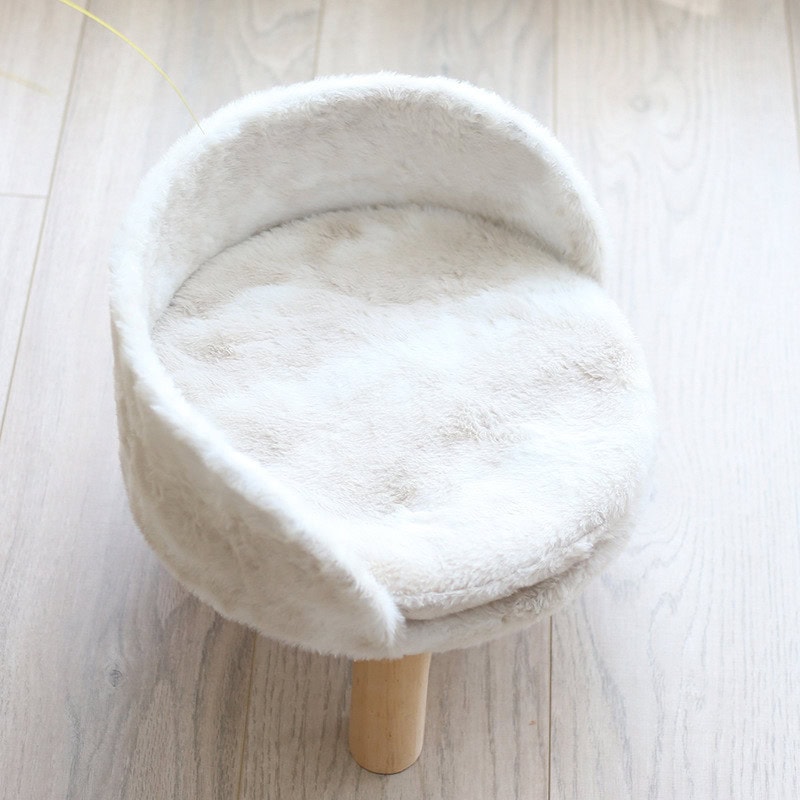 Soft white plush pet bed with a cozy round design, perfect for cats and small dogs, available at Monalisa Store for comfortable and stylish pet sleeping options.