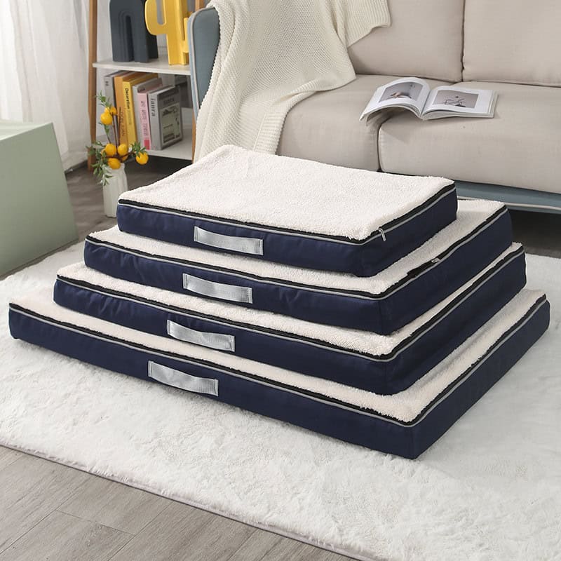 Plush pet bed stack with navy blue exterior and soft white interior, ideal for dogs or cats, in a cozy living room setting for comfort and relaxation.