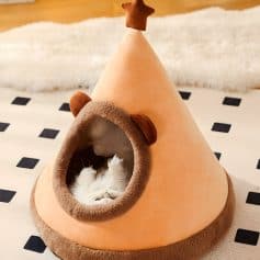 Cozy cat bed shaped like a forest cottage with a sleeping kitten inside, soft plush materials, cute bear ears, perfect for pet comfort and fun decor, ideal for pet owners and animal lovers.
