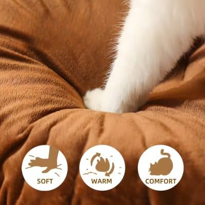 Luxurious white cat paw resting on soft brown fabric, emphasizing comfort and warmth.
