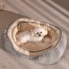 Luxurious pet bed with plush interior, suitable for small dogs, placed on a textured surface, showcasing comfort and style for pet owners seeking high-quality pet accessories.